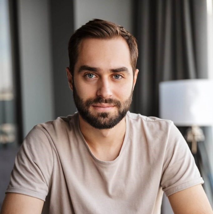 concentrated serious young man indoors at home F46MVGY 683x1024 2
