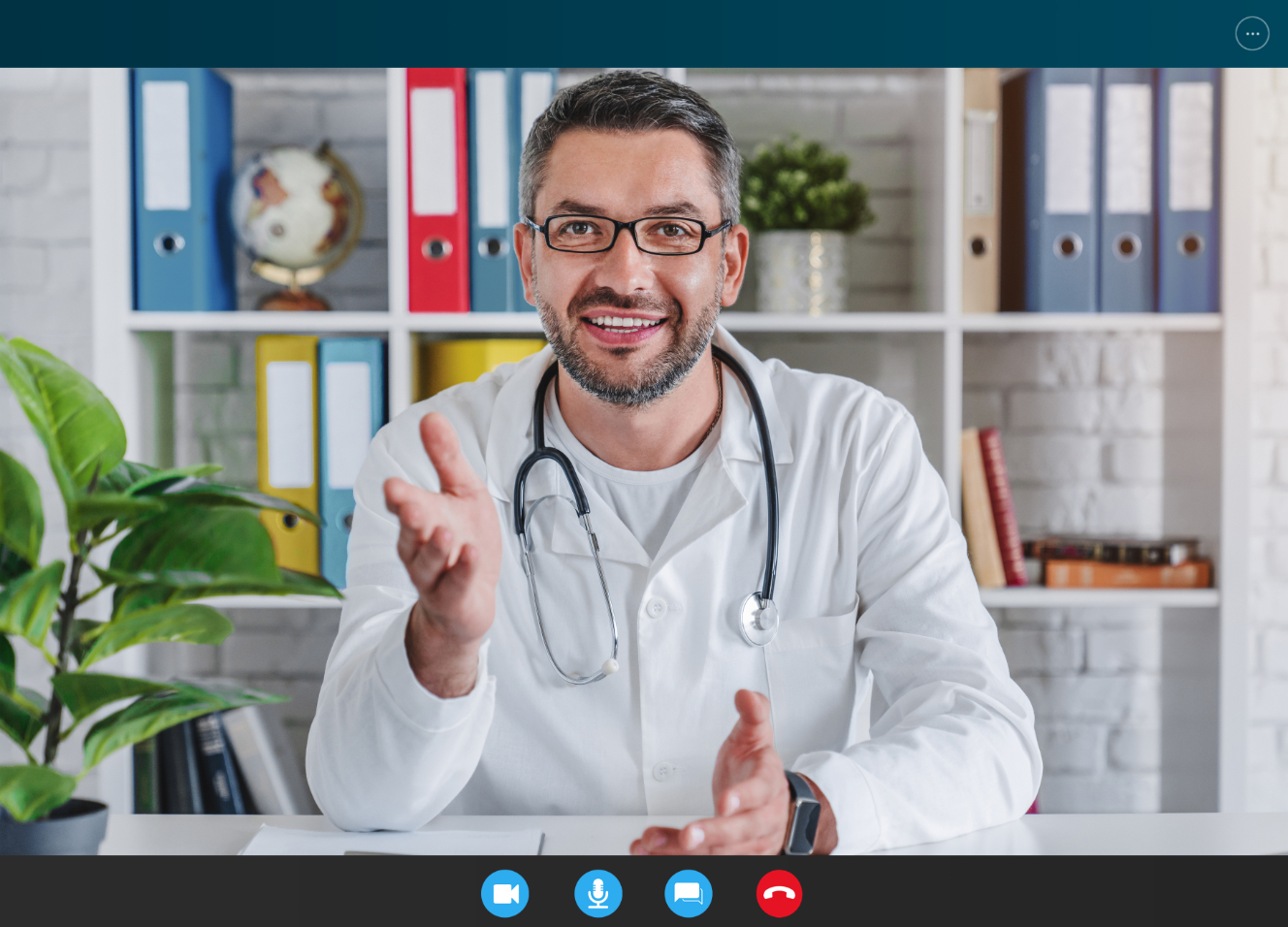 middle aged smiling doctor talking to camera in vi 7GQLXRC 1