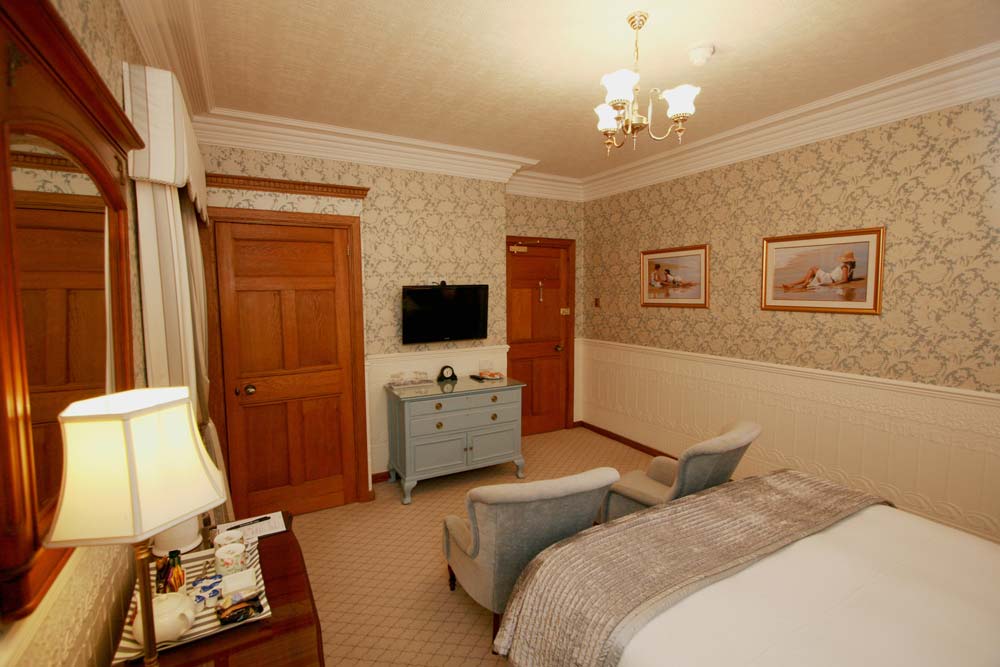 The Edwardian Room with period wallpaper and comfortable seating